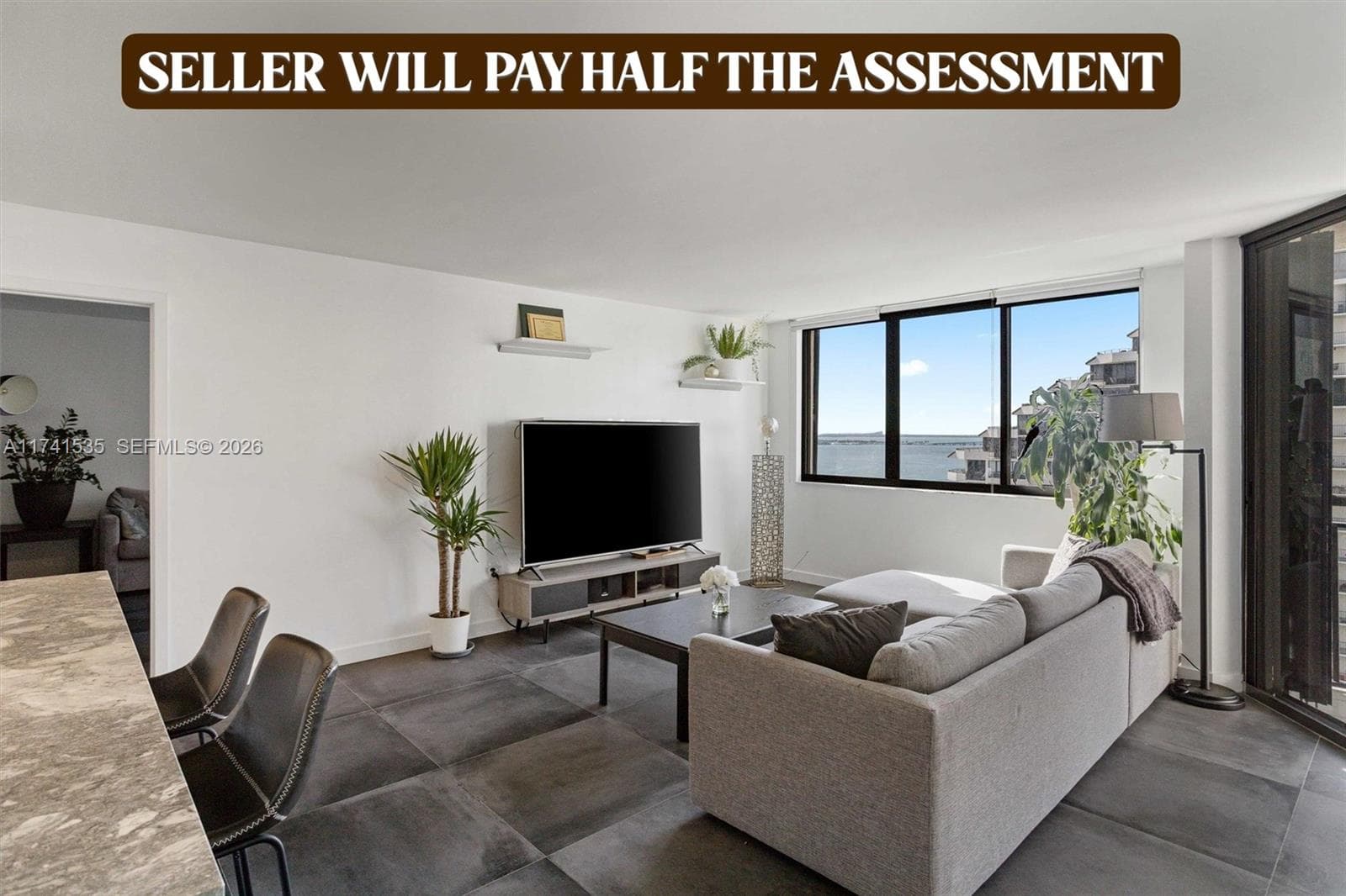 The spacious living area seamlessly connects to a stylish kitchen with high-end finishes, making it perfect for entertaining. Relax while enjoying the picturesque scenery or step onto the balcony for a closer look at the serene waterfront.